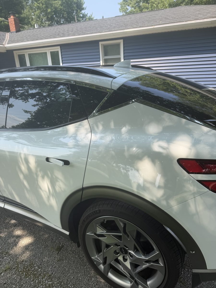 Rear quarter panel and wheel of a Genesis GV60 after detailing