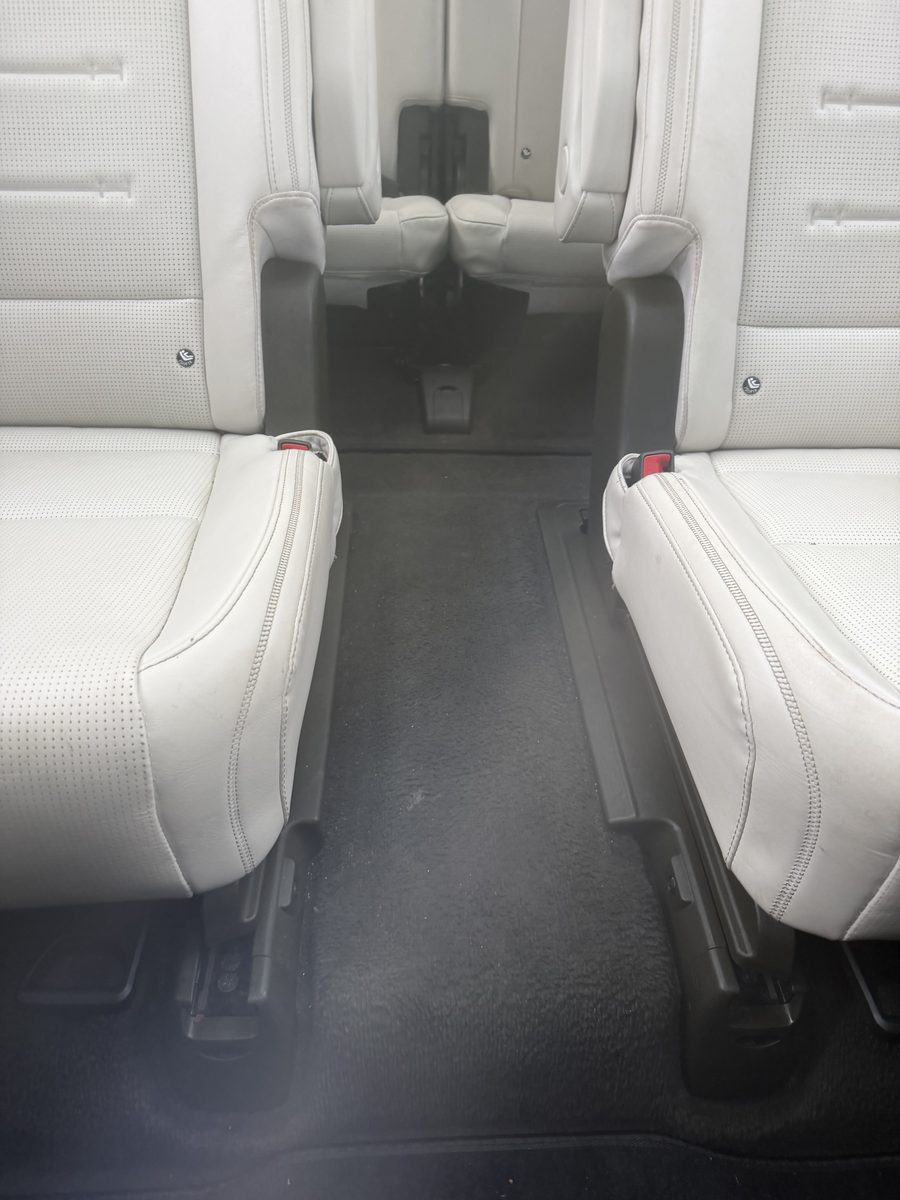 Third-row leather seating cleaned and dressed in an SUV